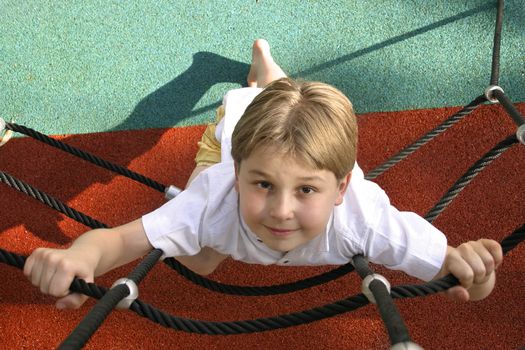 Young boy on climbing ropes - playground 