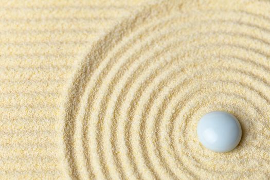 White muddy drop on a surface of yellow sand - abstract background