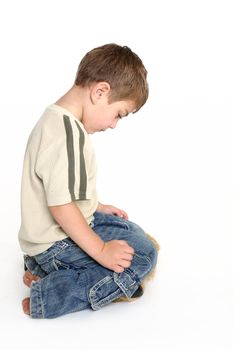 A toddler bows his head in shame.