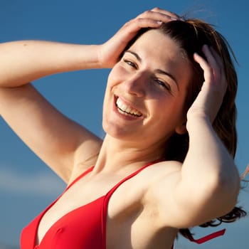 Outdoor portrait of a beautiful happy young woman on the beach