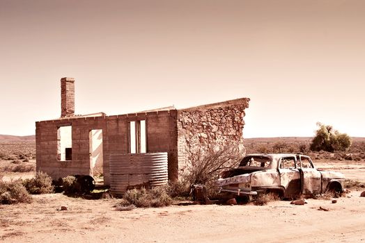 old wrecked car and ruins in the desert