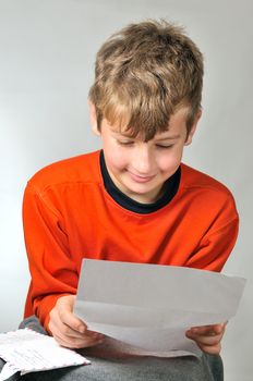 
boy reads a letter he received from friends 