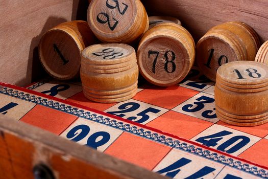 Kegs for game in a lotto, corresponds to game bingo, in a wooden box with cards for this game.