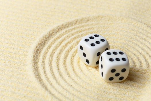 Dices on a sand surface - an abstract art composition in yellow tones