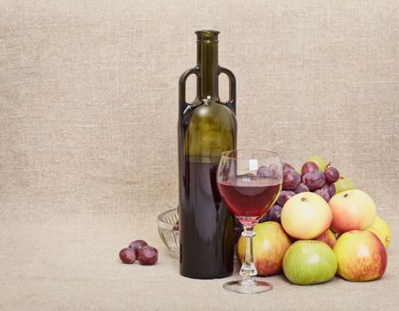 Wine bottle, glass and fruit on canvas - a still-life