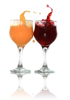 Two goblets of orange and cherry juice isolated on white background with clipping path