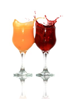 Two goblets of orange and cherry juice isolated on white background with clipping path