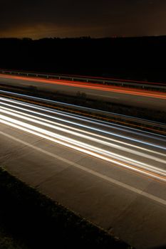 highway at night with car traffic and lights