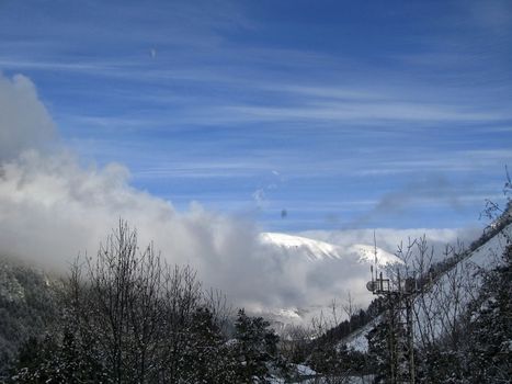 Mountain under the blue sky and the clouds