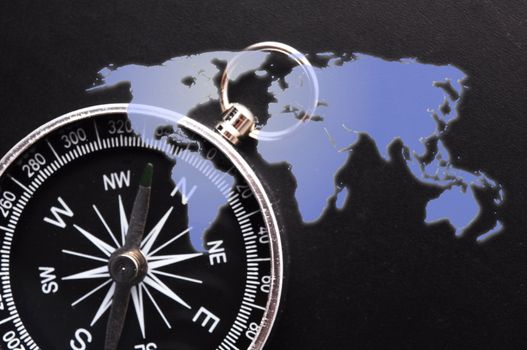 compass and world map showing travel or adventure concept