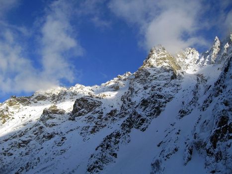 Mountain under the blue sky and the clouds