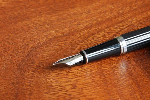 business fountain pen on a wood desktop in an office