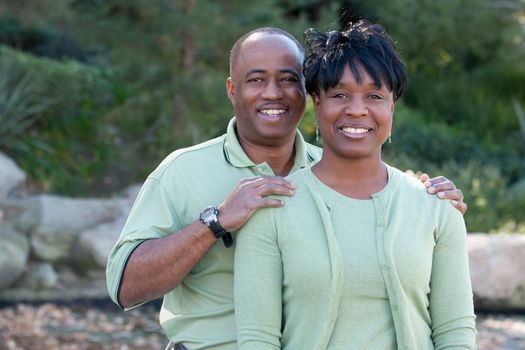 Attractive and Affectionate African American Couple posing in the park.