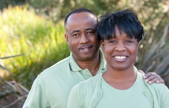 Attractive and Affectionate African American Couple posing in the park.