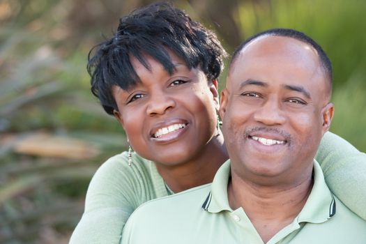 Attractive and Affectionate African American Couple posing in the park.