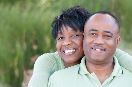 Attractive and Affectionate African American Couple posing in the park.