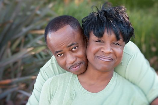 Attractive and Affectionate African American Couple posing in the park.