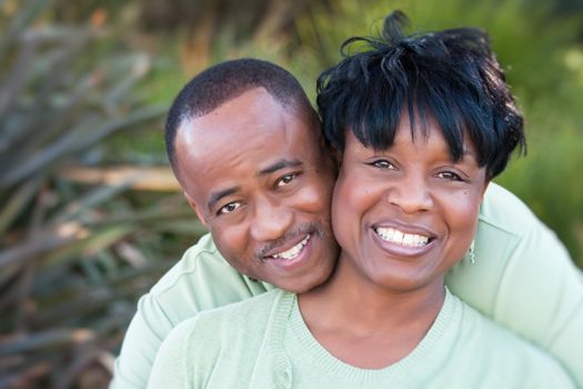 Attractive and Affectionate African American Couple posing in the park.