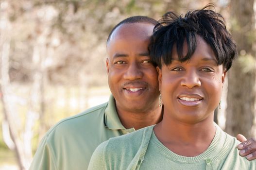 Attractive and Affectionate African American Couple posing in the park.