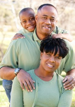 Attractive African American Man, Woman and Child posing in the park.