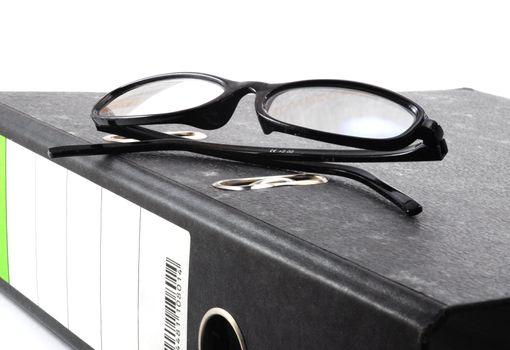 eye glasses and folder in the office showing paperwork concept