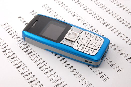 blue cell phone over business chart showing success