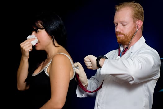 A patient receives a checkup.  Focus on hands and stethoscope