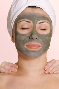 A female enjoys the pampersing with a beauty mask and relaxing massage