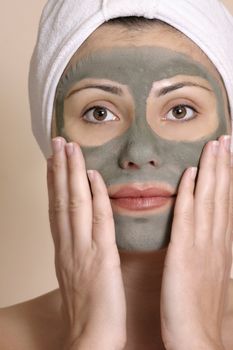 Beautiful girl wearing a purifying beauty mask on her face.