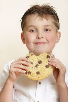 Boy with large cookie and smiling