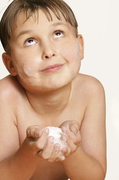 Boy holding soap with expression.   