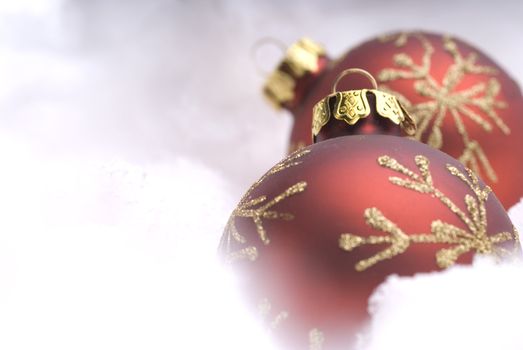 Red Christmas balls on snow close-up