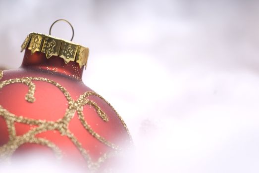 Red Christmas ball on snow close-up