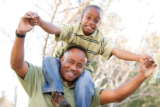 African American Man and Child Having Fun in the Park.