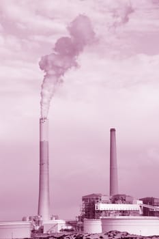 Smokestacks of power station on sky background
