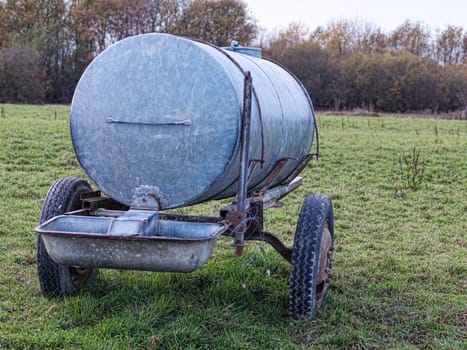Metal water container in a countryside meadow