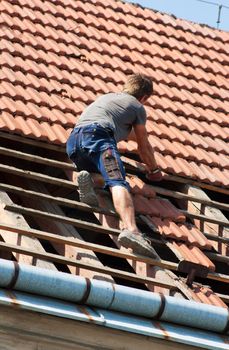 Man working in the roof of a building