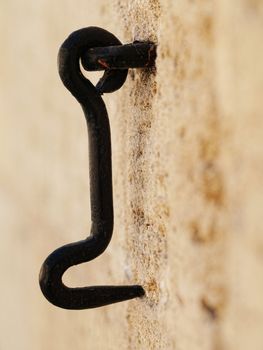 Metal hook on vintage wall with selective focus