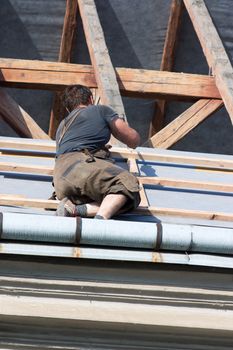 Man working in the roof of a building