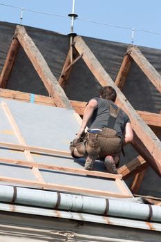 Man working in the roof of a building