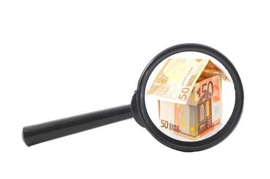 house of money and magnifying glass showing real estate concept