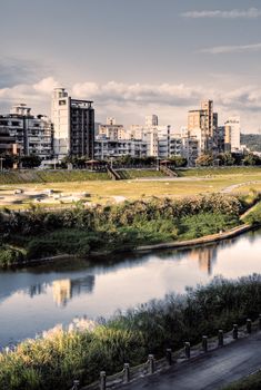 City scenery with house and river under the dramatic sky.