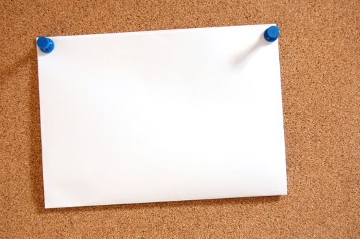 blank and empty sheet paper with copyspace on bulletin board in office