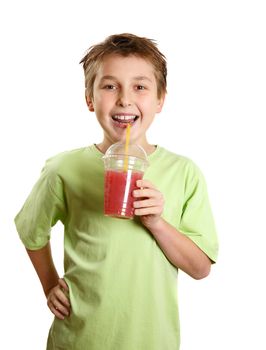 Happy smiling child holding a fresh fruit juice in his hand.