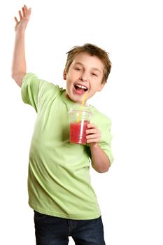 A boy jumps in delight.   He is holding a healthy fruit juice and smiling with glee.