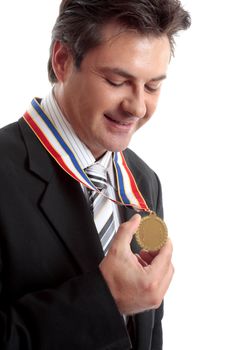 Business awards.   Businessman admires his gold medal