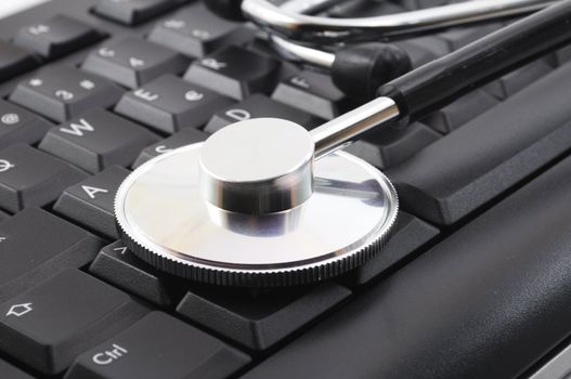 stethoscope on computer keyboard showing medical or pc support concept