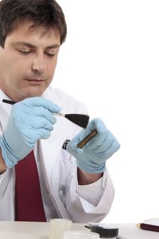 Forensic scientist tests for fingerprints in attempt to solve a crime..  Focus to hands.