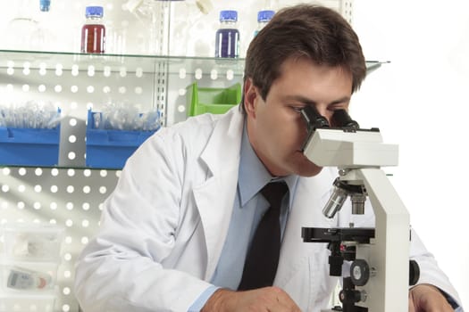 A researcher observes a substance on a slide under a stereo microscope