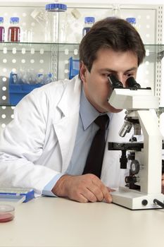 Scientist, biologist, geneticist,  researcher  or healthcare worker studying an object under the microscope